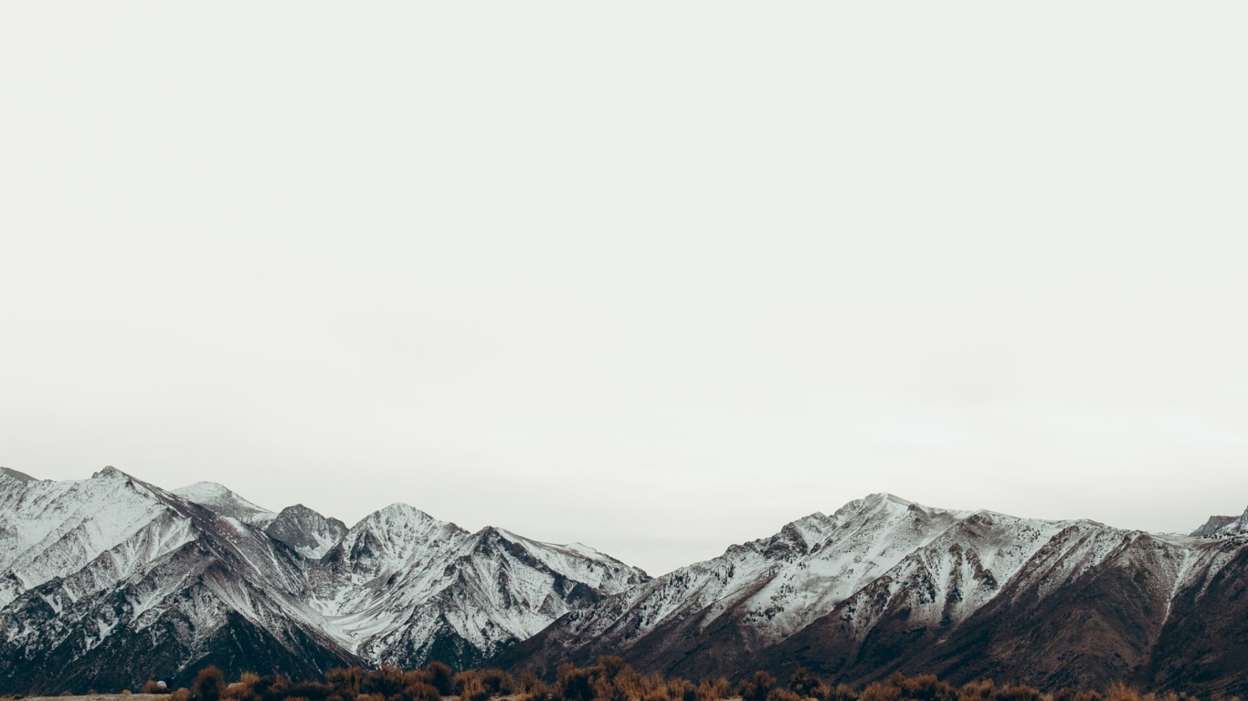 snowy mountain range near the Fiordland National Park in the background